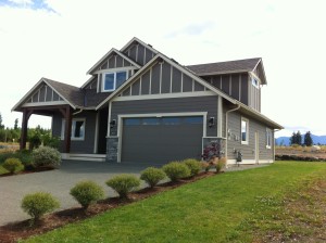 This custom built home by Lawmar Contracting at The Ridge in Courtenay shows the mountain views available on buiding lots for sale. 