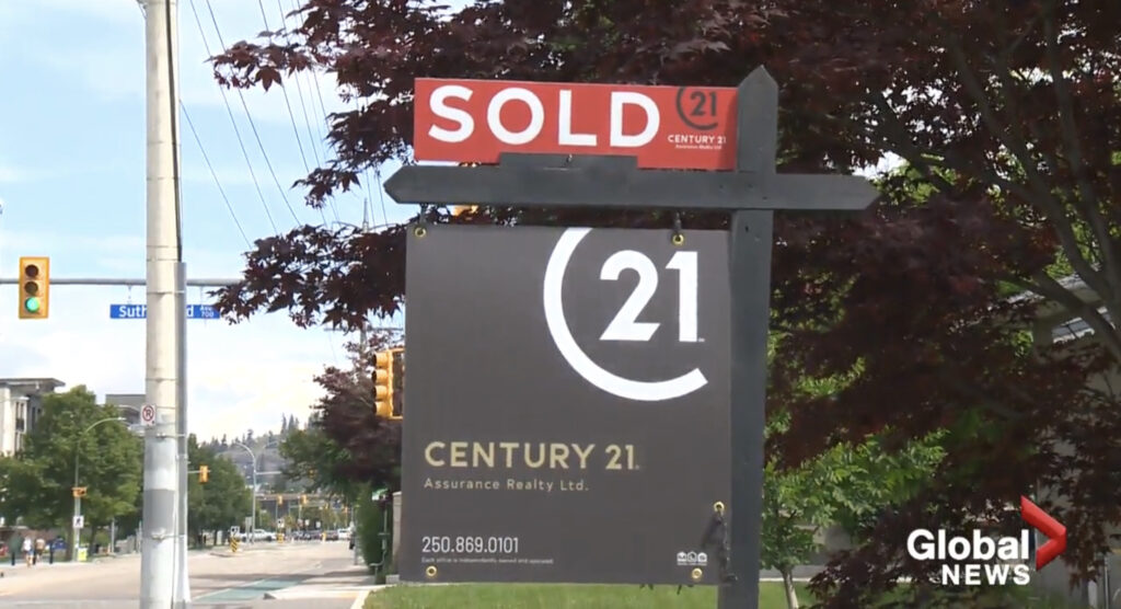 A real estate sold sign with the Century 21 logo